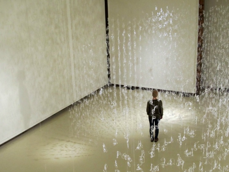 Art student views shadow play of hot glue installation titled Numinous by Gerri Sayler at Spurgeon Art Gallery