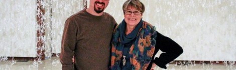 the artists Andy Behrle and Gerri Sayler standing next to each other at opening reception fort hot glue installation entitled Numinous